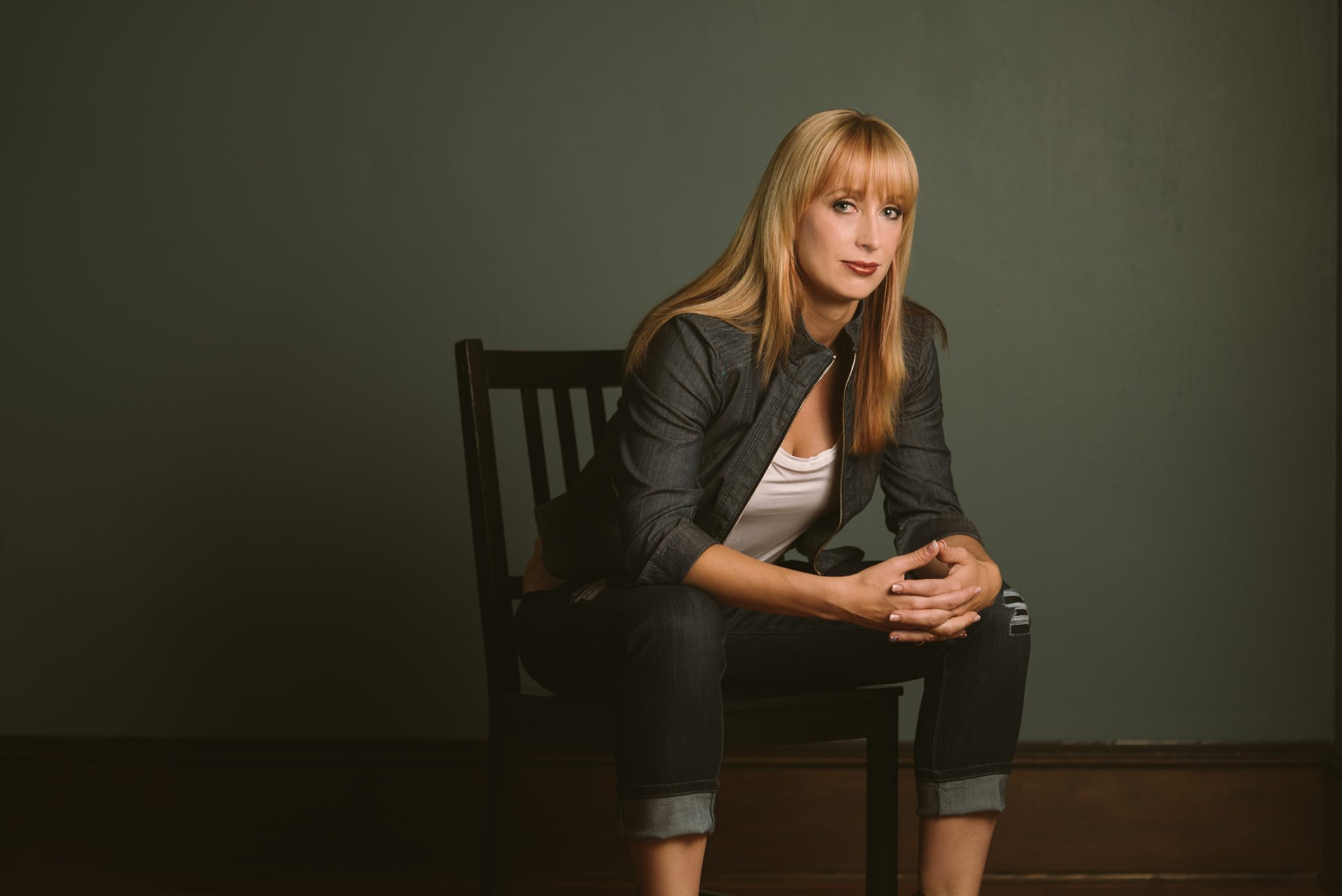 heather posing in a chair for a photo shoot